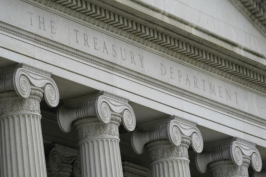 FILE - The Treasury Building is viewed in Washington, May 4, 2021.  The U.S. Treasury Department said Thursday that it has imposed its first set of sanctions on two companies that shipped Russian oil in violation of a multinational price cap.