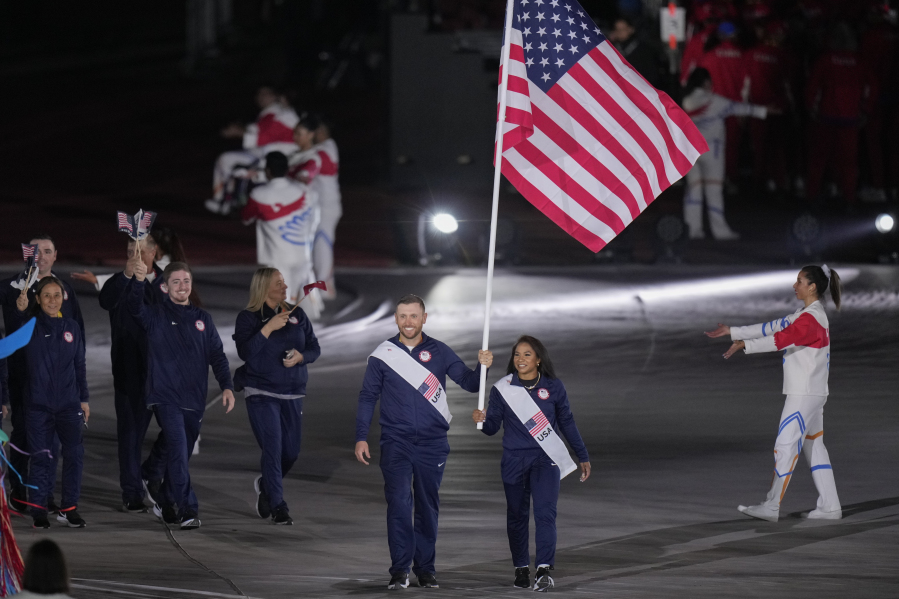 Jordan Chiles and Vincent Hancock of the United States carry their country's flag during the opening ceremony of the Pan American Games at the National Stadium in Santiago, Chile, Friday, Oct. 20, 2023.