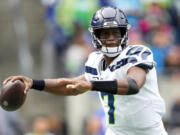 Seattle Seahawks quarterback Geno Smith passes against the Carolina Panthers during the first half of an NFL football game Sunday, Sept. 24, 2023, in Seattle.
