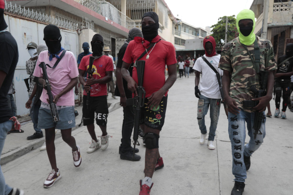 Armed members of "G9 and Family" march in a protest against Haitian Prime Minister Ariel Henry in Port-au-Prince, Haiti, Tuesday, Sept. 19, 2023.