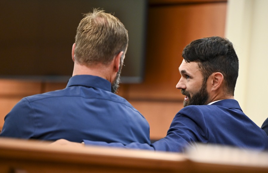 Defendants Matthew Collins, left, and Christopher "Shane" Burbank talk in the gallery during the pre-trail motion in the trial of Tacoma Police Officers Christopher Burbank, Matthew Collins and Timothy Rankine in the killing of Manny Ellis at Pierce County Superior Court Monday, Sept. 18, 2023, Tacoma, Wash.