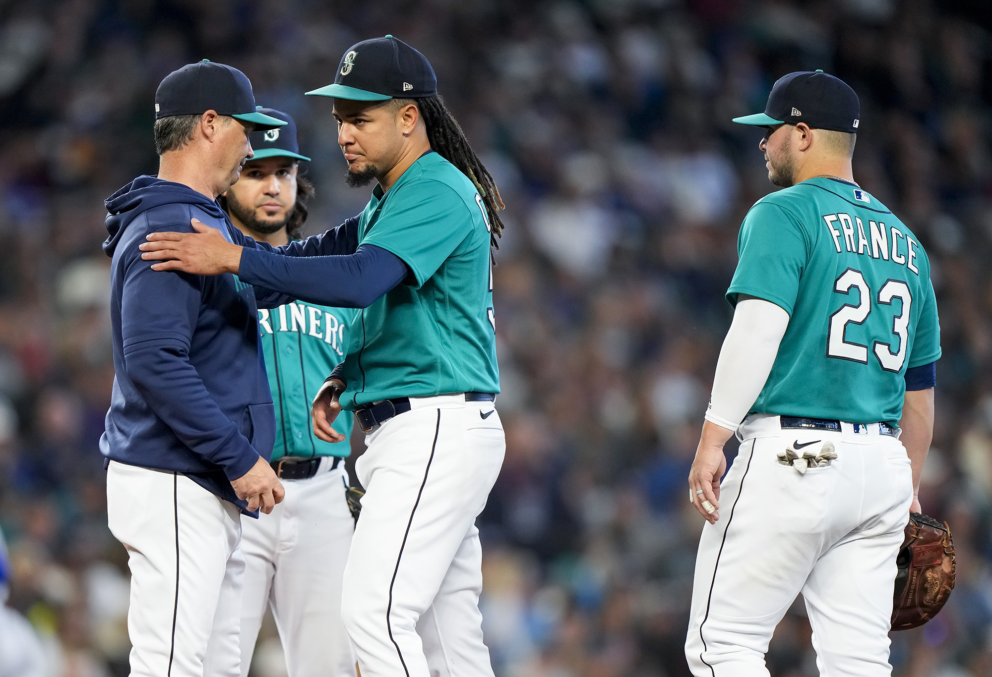 Seattle Mariners manager Scott Servais, left, pulls starting pitcher Luis Castillo from a baseball game against the Texas Rangers during the third inning, Saturday, Sept. 30, 2023, in Seattle.