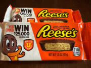 Two packages of Reese's candy featuring a sweepstakes ad are shown in Ann Arbor, MI., on Friday, Oct. 13, 2023. Reese's may be violating state and federal laws with the sweepstakes offer.