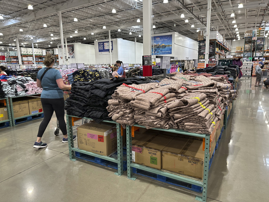 A shopper passes by a display of winter wear in a Costco warehouse on Wednesday, Oct. 4, 2023, in Sheridan, Colo. On Tuesday, the Commerce Department releases U.S. retail sales data for September.