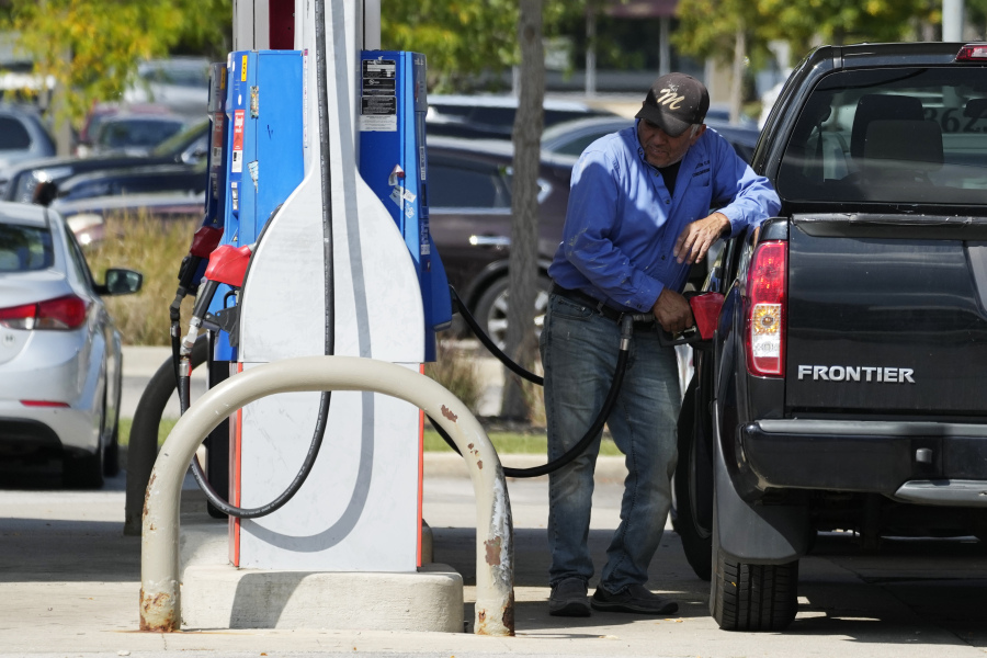 A man fuels his truck at a gas station in Palatine, Ill., Wednesday, Sept. 13, 2023. Higher longer-term interest rates coincide with other threats to economic growth, from higher gas prices and the resumption of student loan payments to the autoworkers' strike and the risk of a government shutdown next month. (AP Photo/Nam Y.