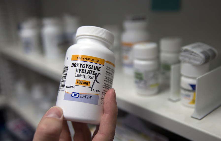 FILE - A pharmacist holds a bottle of the antibiotic doxycycline hyclate in Sacramento, Calif., July 8, 2016. The Centers for Disease Control and Prevention announced Monday, Oct. 2, 2023, that it plans to endorse the antibiotic as a post-sex morning after pill that gay and bisexual men can use to avoid some increasingly common sexually transmitted diseases.