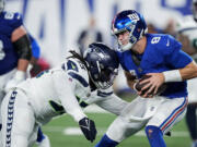 Seattle Seahawks defensive tackle Myles Adams (95) sacks New York Giants quarterback Daniel Jones (8) during the fourth quarter of an NFL football game, Monday, Oct. 2, 2023, in East Rutherford, N.J.