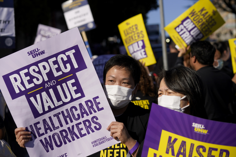 File - Medical workers and supporters carry signs and march as they protest outside of a Kaiser Permanente facility in San Francisco, Wednesday, Oct. 4, 2023.