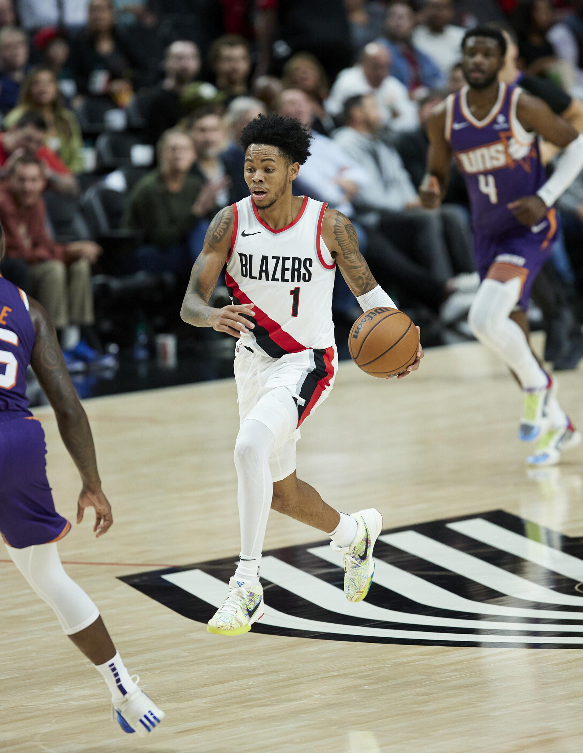 Portland Trail Blazers guard Anfernee Simons brings the ball up against the Phoenix Suns during the second half of an NBA preseason basketball game in Portland, Ore., Thursday, Oct. 12, 2023.