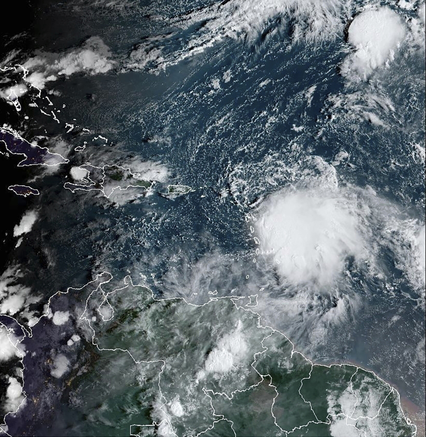 This satellite image provided by NOAA on Monday, Oct. 2 2023 shows Tropical Storm Philippe, center right. Philippe is threatening to unleash heavy rains and flash flooding in the Leeward Islands on Monday before eventually recurving out into the central Atlantic where it could gain hurricane status around midweek, forecasters say.