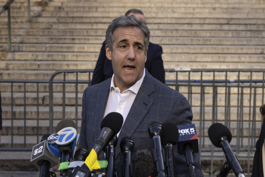Michael Cohen speaks to members of media as he arrives for former President Donald Trump's civil business fraud trial at New York Supreme Court, Tuesday, Oct. 24, 2023, in New York.