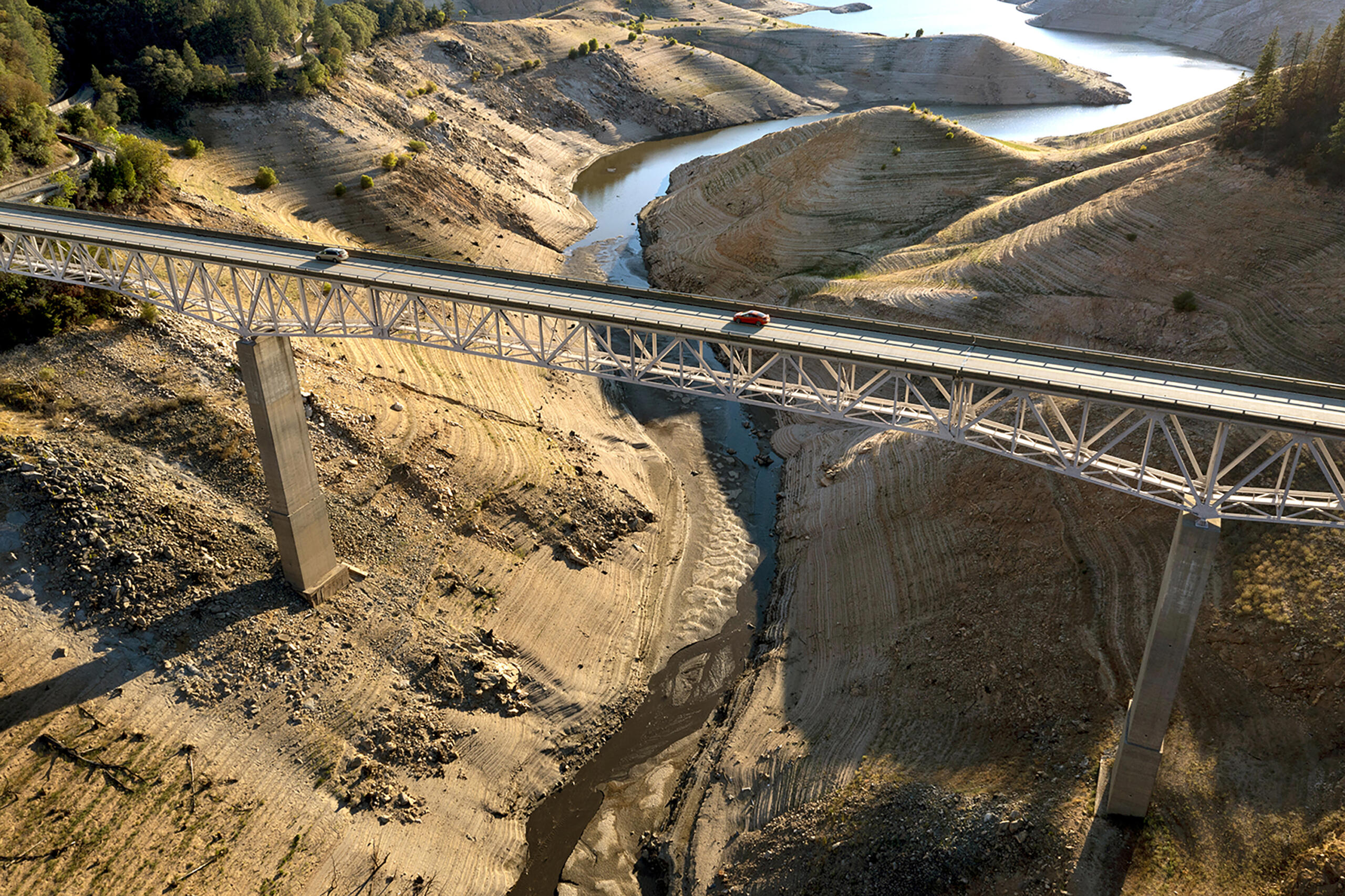 Vehicles cross the Enterprise Bridge at Lake Orovillein in July 2021, with water levels in the biggest state reservoirs well below average.