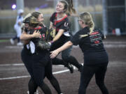 Union's Madison Wirth (from right), Sophia Rickard and Victoria Ross celebrate after the final out in a 15-11 win over Skyview in the 4A district slowpitch softball championship game at Heritage High School on Thursday, Oct. 19, 2023.