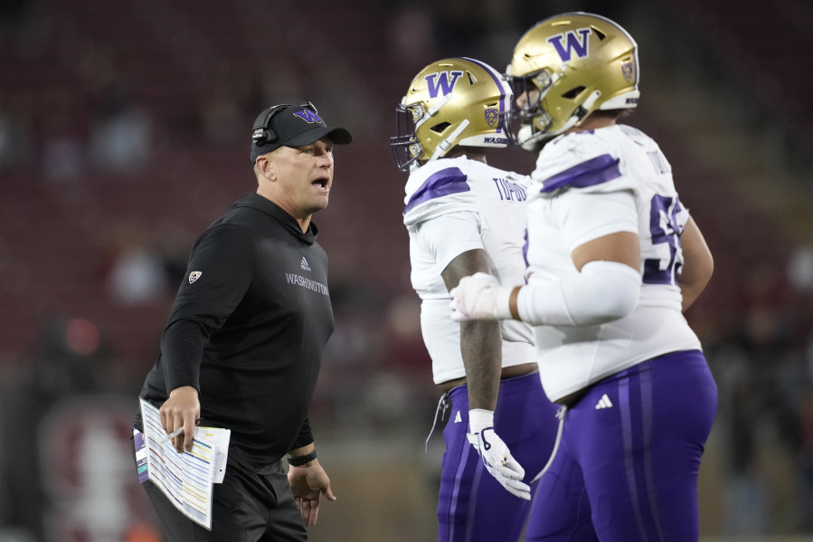 Washington coach Kalen DeBoer, left, reacts toward players after Washington stopped Stanford on a 2-point conversion attempt during the second half of an NCAA college football game in Stanford, Calif., Saturday, Oct. 28, 2023.