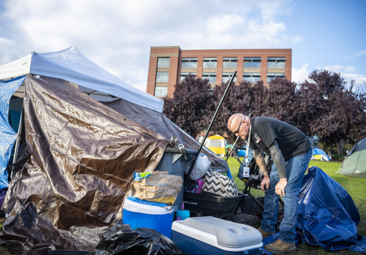 Lonny Klugman, a member of the city of Vancouver's Homeless Assistance and Resources Team, talks to an encampment resident outside Vancouver City Hall. Klugman is a veteran who experienced homelessness and uses his experience to help others.