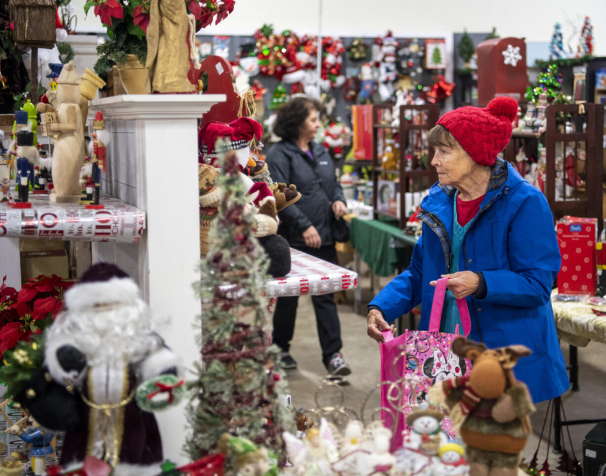Carol Tuttle of Vancouver looks for Christmas decorations Friday at ReTails Thrift Store. The holiday store will run the entire season, wrapping up around the end of Christmas.