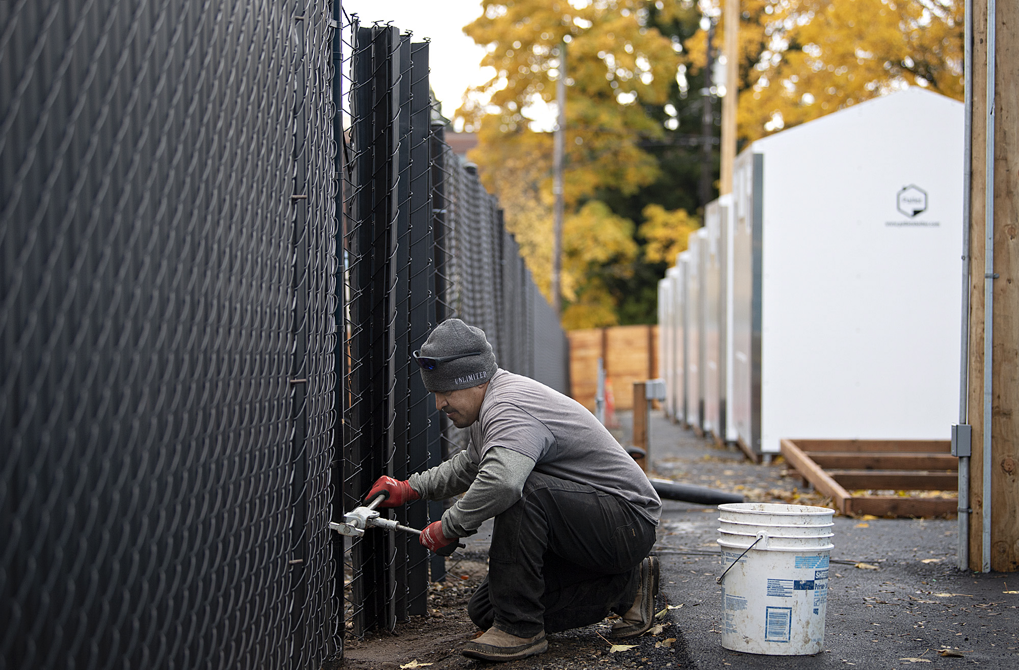 Jerry Murillo of Unlimited Fence lends a hand as construction continues at the third Safe Stay community in downtown Vancouver on Tuesday morning, Nov. 7, 2023. The city approved emergency declaration for homelessness on Monday night.