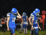 La Center sophomore Landen Randall, left, and teammates walk off the field Friday, Nov. 10, 2023, after the Wildcats’ 21-7 playoff loss to Omak at La Center High School.