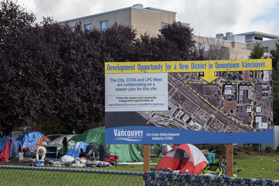 A sign near Vancouver City Hall depicts development plans for the area as some residents begin to pack their belongings and leave.