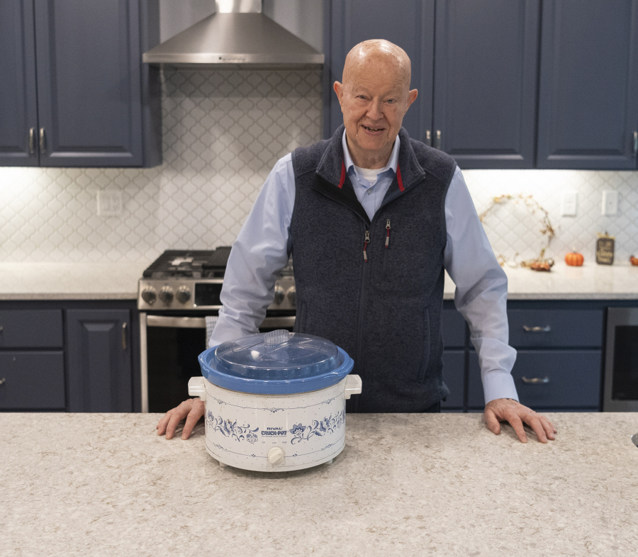Doug Hamilton stands for a portrait with his trusty slow cooker at his home in the Sifton area northeast of Vancouver. Hamilton has been perfecting a slow-cooked barbecue beans recipe for 30 years.