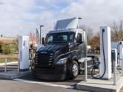 A new eCascadia semitruck sits at a charging station Nov. 16 at Electric Island in Portland. The rig, donated by Daimler Truck, will be used to help collect and sort thousands of pounds of food that Walk &amp; Knock receives every year.