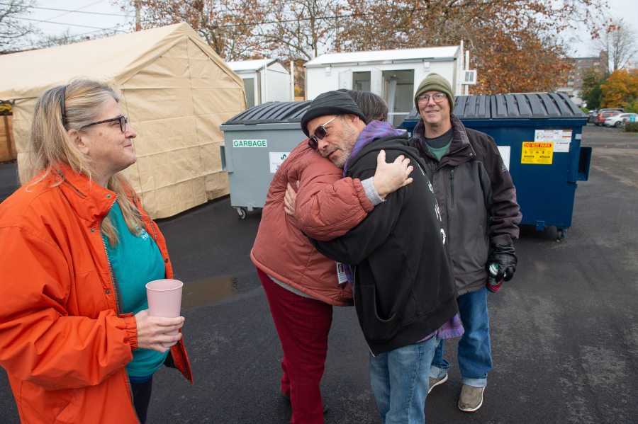 Outsiders Inn Co-Director, Adam Kravitz hugs Sabrina Thayer, a “success story” graduate of the previous iterations of the housing program. Sabrina’s husband, James Thayer is at right, and Co-Director Ren Autrey is at left.