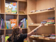Rachal White organizes the children&rsquo;s section of the bookstore.
