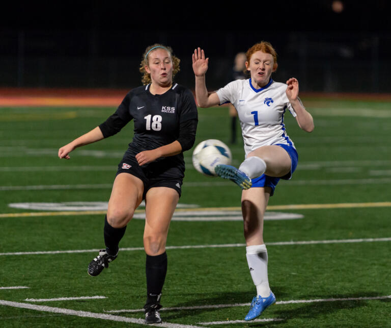 Klahowya sophomore Seraphina Bell and La Center senior forward Mikaela Bright compete for a loose ball in a 1A State girls soccer semifinal game on Friday, Nov. 17, 2023, at Mount Tahoma Stadium in Tacoma.