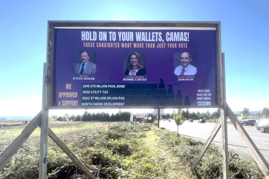 Drivers pass an anonymous campaign sign targeting three Camas officials near the intersection of Southeast 192nd Avenue and Southeast Brady Road on Oct. 28.