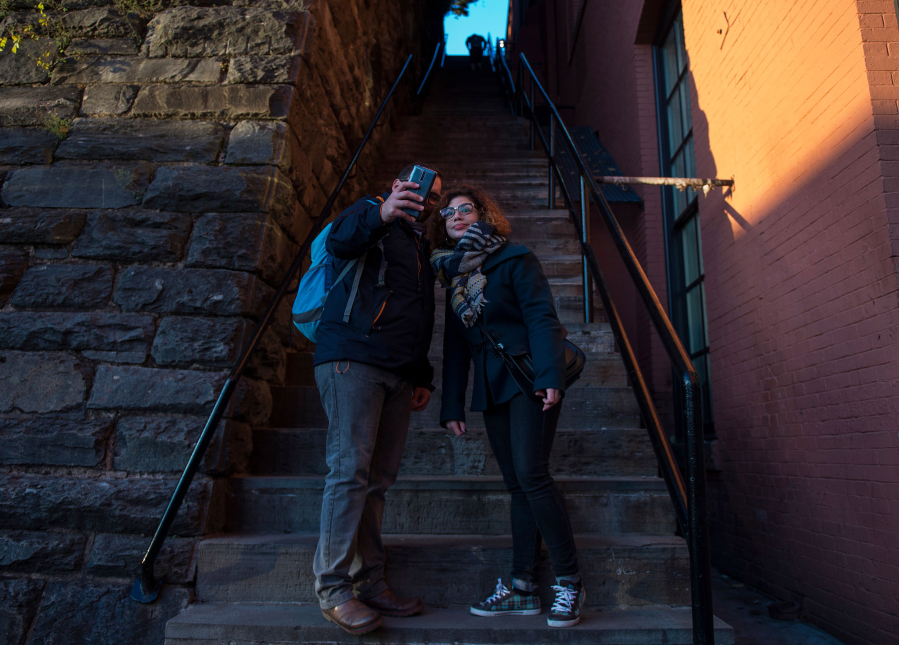 Tourists take a selfie at the bottom of the stairs made famous by the 1973 movie "The Exorcist," in the Georgetown neighborhood of Washington, D.C.