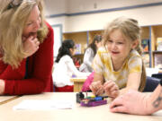 Gause Elementary School Principal Tami Culp helps a student with her robot prototype during a robotics lesson in December. Culp has assumed leadership duties for the Washougal Learning Academy after the Washougal School District eliminated the online school's principal position due to lower-than-expected enrollment.
