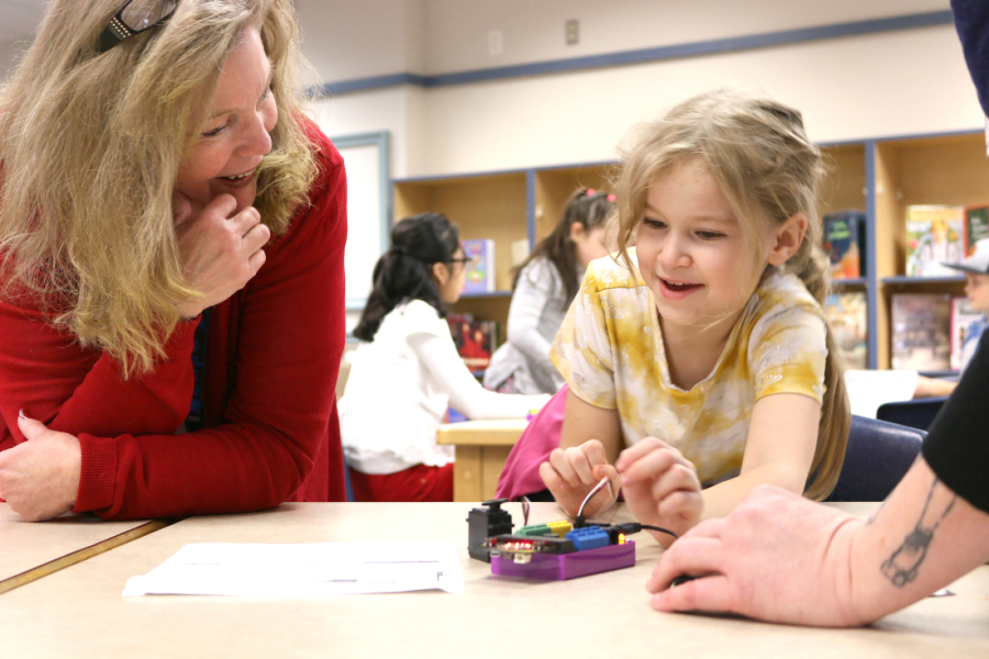 Gause Elementary School Principal Tami Culp helps a student with her robot prototype during a robotics lesson in December. Culp has assumed leadership duties for the Washougal Learning Academy after the Washougal School District eliminated the online school's principal position due to lower-than-expected enrollment.