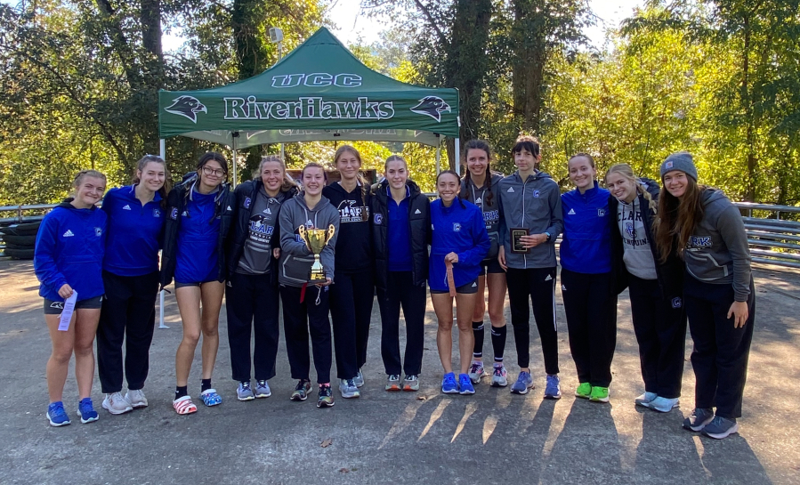 The Clark College women's cross country team poses with the first-place trophy after winning the Northwest Athletic Conference Southern Region championhip on Oct. 28, 2023 in Roseburg, Ore. Individual champion Sydnee Boothby, fourth from right, set a Clark record for 5,000 meters at that race with a time of 17 minutes, 20.4 seconds.