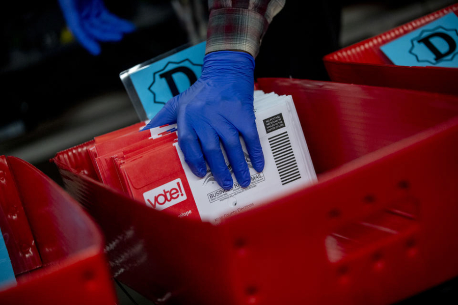 Ballots are processed at the King County Elections headquarters in Renton for Washington state&Ccedil;&fnof;&Ugrave;s primary election on March 10, 2020. Though gloves have always been optional for elections workers, it has become mandatory to prevent COVID-19.