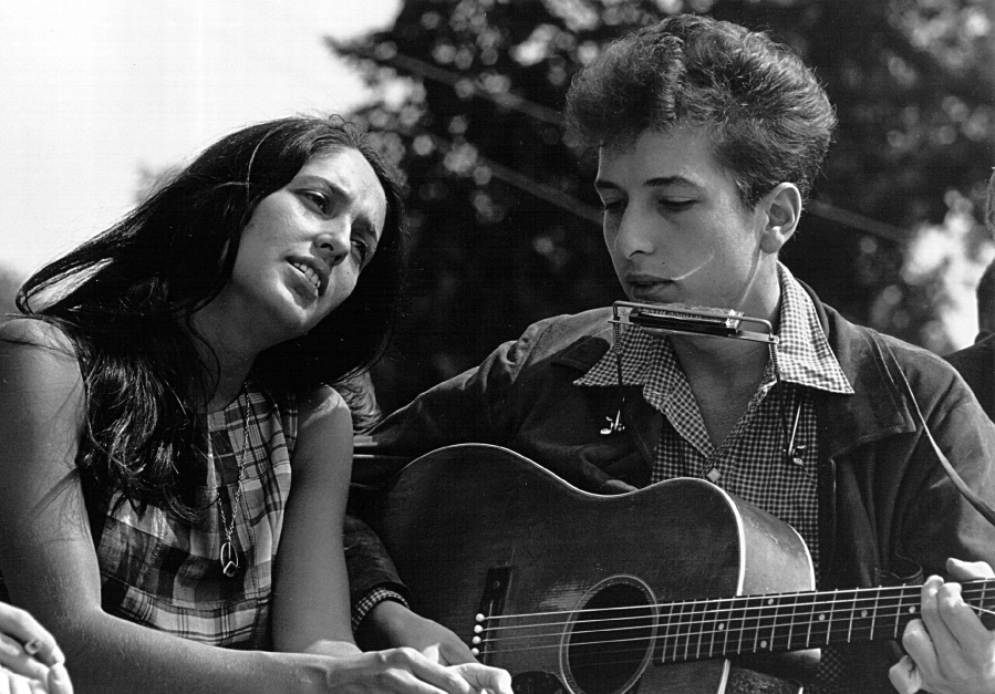 Folk singers Joan Baez, left, and Bob Dylan perform during a civil rights rally on Aug. 28, 1963, in Washington, D.C.