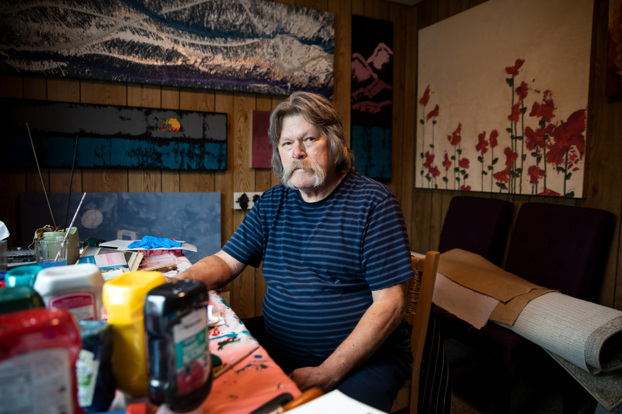 Sam Taylor, 73, stands Sept. 25 in one of his painting spaces in his home in Everett.