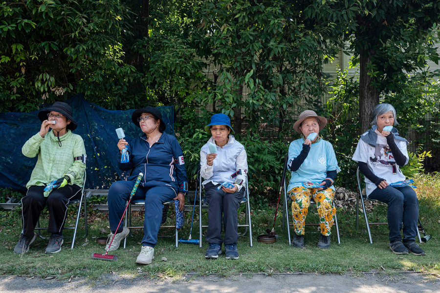 This photo taken on July 27, 2023, shows senior citizens enjoying cool popsicles after playing the croquet-inspired game of &ldquo;gateball&rdquo; at a park in suburban Tokyo. (Richard A.