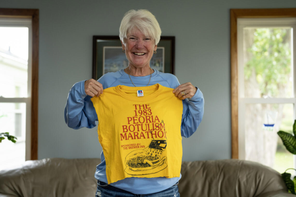 Mary Lou Dobrydnia holds a T-shirt botulism survivors made to commemorate the fifth anniversary of the outbreak.