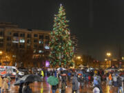Rain soaks a crowd that gathered for the Rotary Club of Vancouver's annual Community Tree Lighting Ceremony  in 2022 at Esther Short Park.