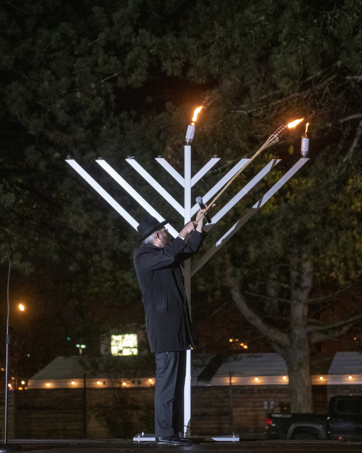 Rabbi Shmulik Greenberg lights the Menorah to celebrate the first day of Hanukkah at a Drive-In Grand Menorah Lighting in a parking lot across the street from the Clark County Historical Museum in 2020.