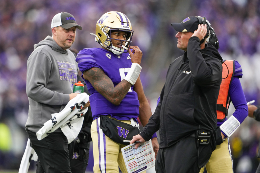Washington quarterback Michael Penix Jr. (9) stands with head coach Kalen DeBoer during a timeout during the second half of an NCAA college football game against Utah, Saturday, Nov. 11, 2023, in Seattle. Washington won 35-28.