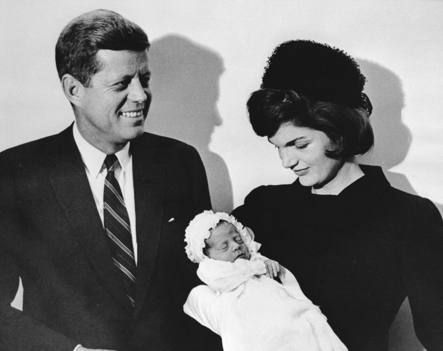 John F. Kennedy and his wife Jacqueline hold their son John during the christening ceremony Dec. 10, 1960, at the chapel of Georgetown University in Washington, D.C.
