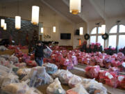 Volunteer Jewel Sholer walks among hundreds of donated toys as she lends a hand at the Salvation Army on Dec. 22, 2022.