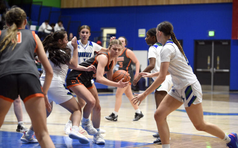 Washougal’s Isabella Albaugh (10) looks for space in the paint as several Mountain View defenders converge during a non-league girls basketball game on Thursday, Nov. 30, 2023, at Mountain View High School.