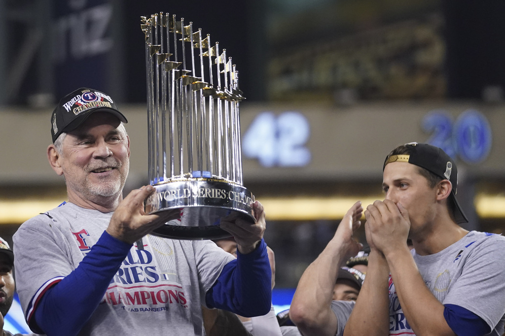 Texas Rangers manager Bruce Bochy holds up the trophy after Game 5 of the baseball World Series against the Arizona Diamondbacks Wednesday, Nov. 1, 2023, in Phoenix. The Rangers won 5-0 to win the series 4-1. (AP Photo/Godofredo A.