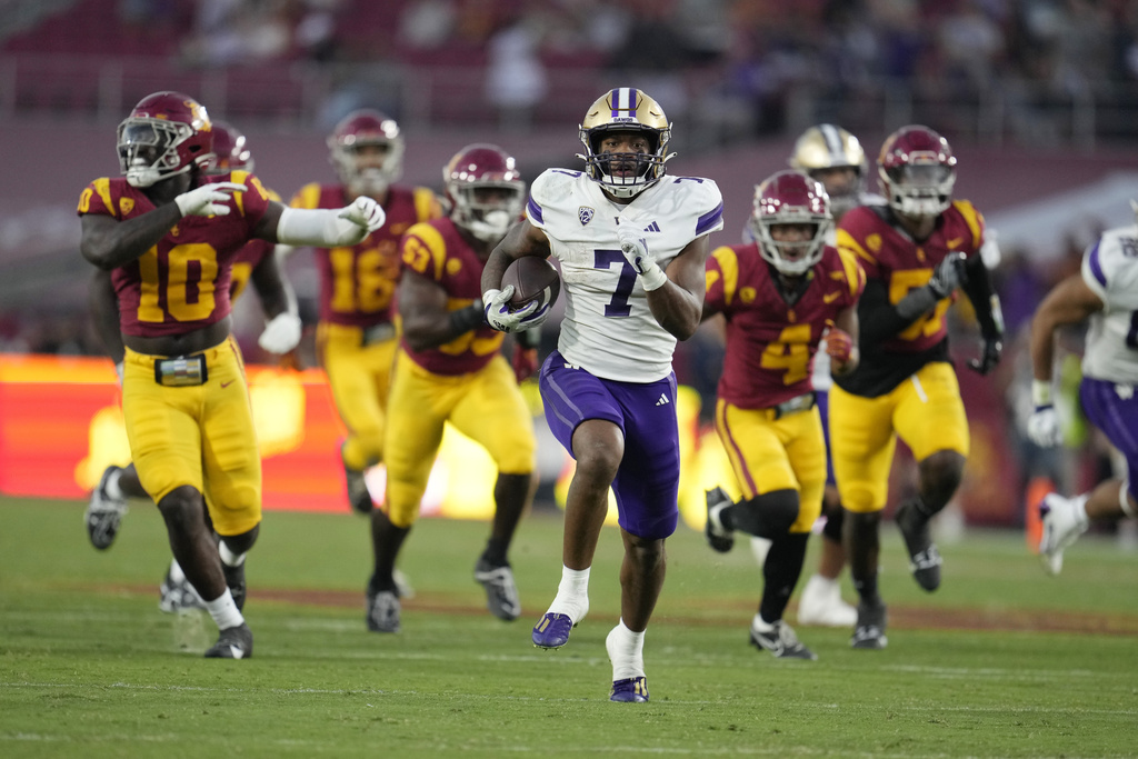 Washington running back Dillon Johnson (7) runs for a touchdown during the first half of an NCAA college football game against Southern California Saturday, Nov. 4, 2023, in Los Angeles.