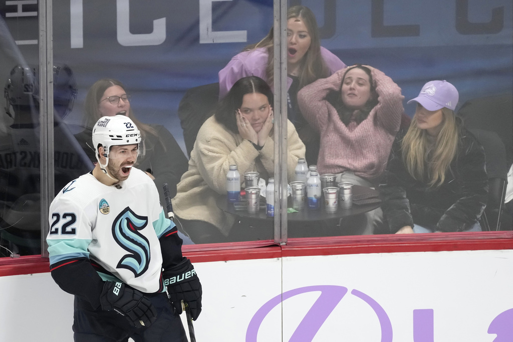 Seattle Kraken right wing Oliver Bjorkstrand celebrates after scoring the go-ahead goal against the Colorado Avalanche as fans react during the third period of an NHL hockey game Thursday, Nov. 9, 2023, in Denver.