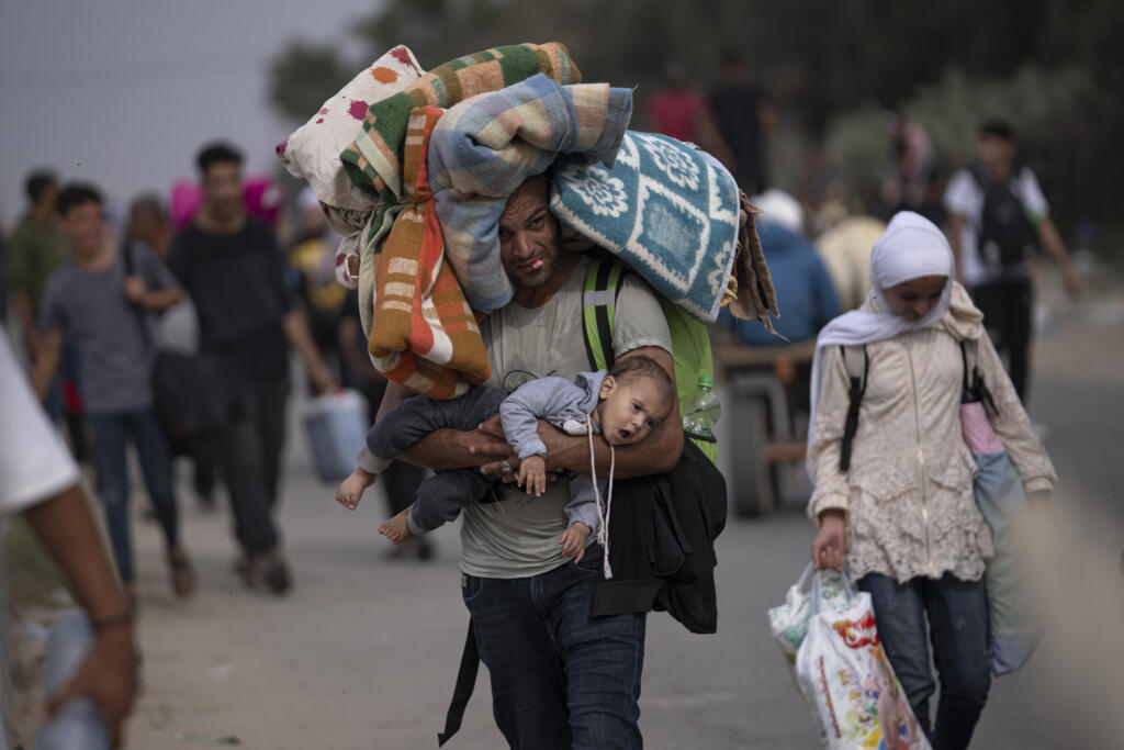 Palestinians flee to the southern Gaza Strip on Salah al-Din Street in Bureij, Gaza Strip, Saturday, Nov. 11, 2023.