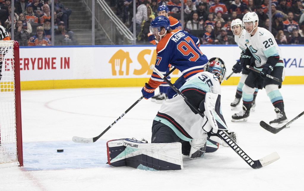 Seattle Kraken goalie Joey Daccord (35) is scored on by Edmonton Oilers' Connor McDavid (97) during the second period of an NHL hockey game, Wednesday, Nov. 15, 2023 in Edmonton, Alberta.