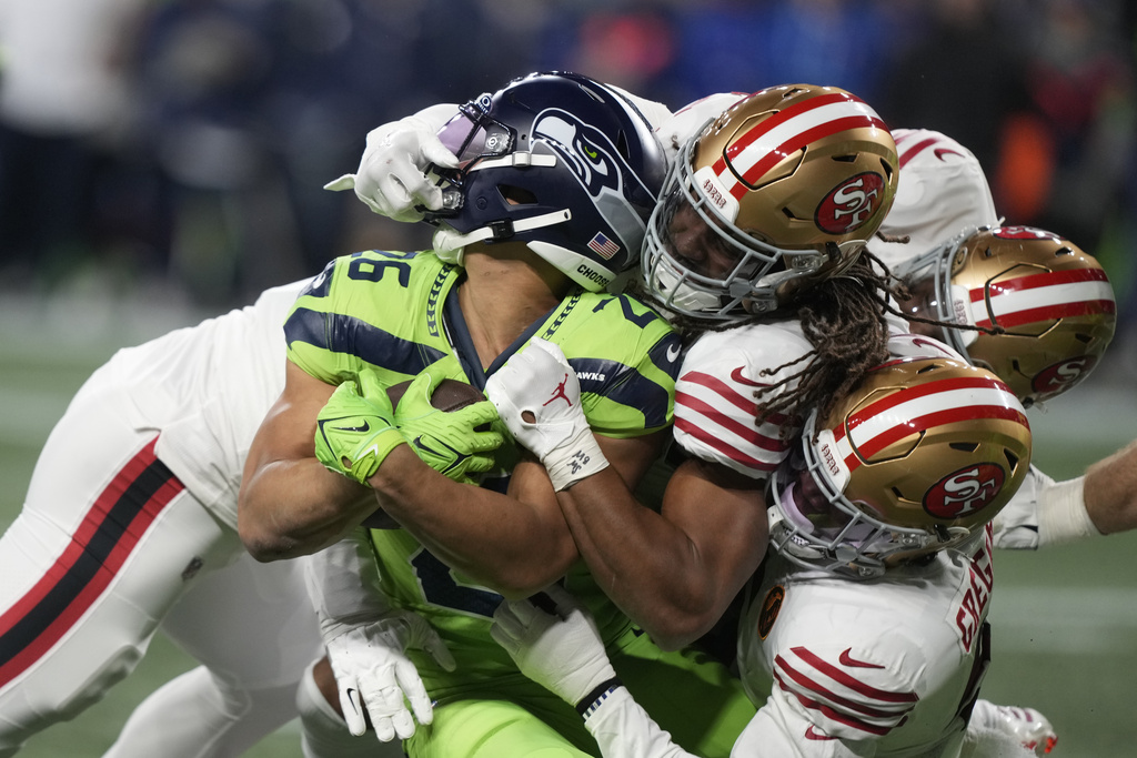 Seattle Seahawks running back Zach Charbonnet (26) is tackled during the first half of an NFL football game against the San Francisco 49ers, Thursday, Nov. 23, 2023, in Seattle.
